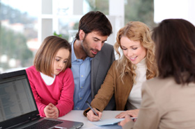 Life Insurance Brokers in Canada Family signing life insurance policy